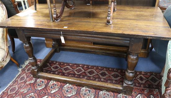 A 17th century style oak centre table, with planked top on turned legs and peripheral stretcher, W.168cm